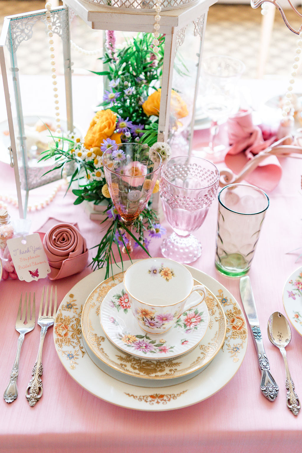 pink wine glasses, teacup and saucer, elegant floral dinnerware, mismatched vintage flatware, pink linens
