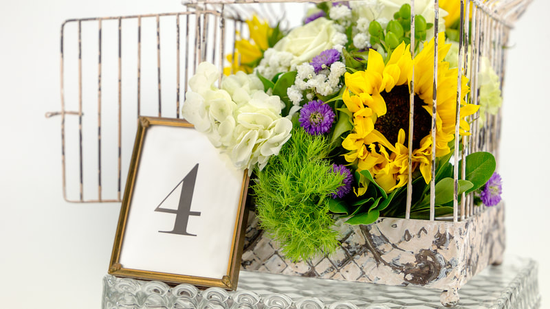 Bird cage, table number and florals