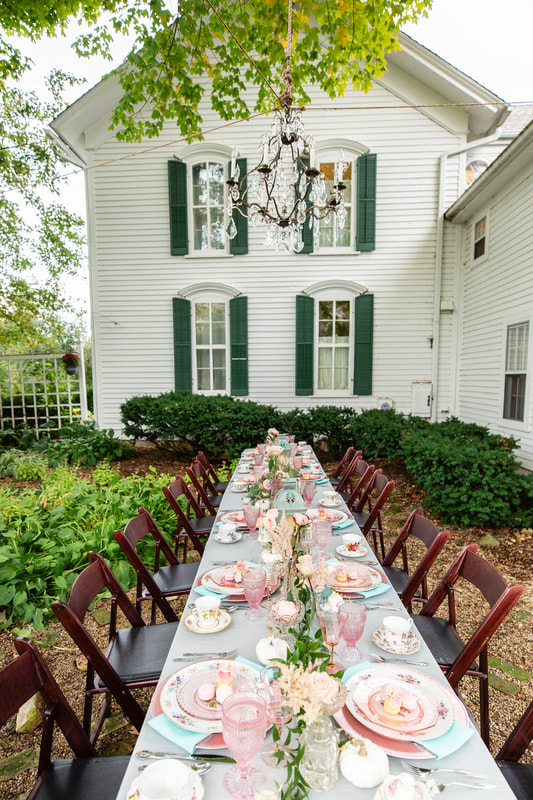 Long table set outside for a pink tea party