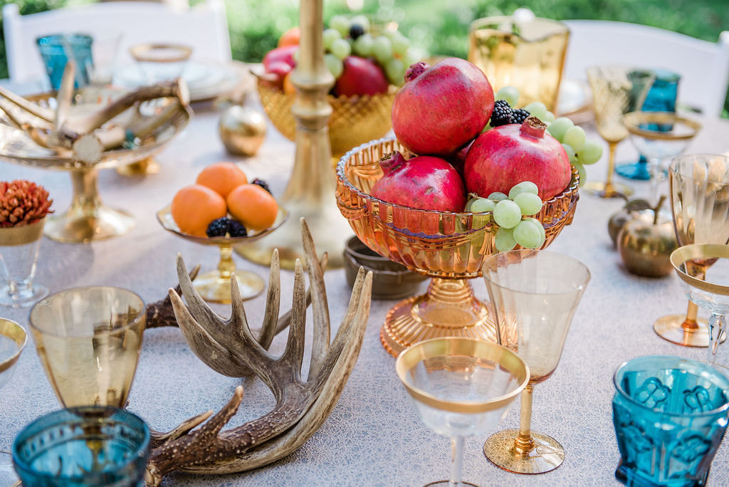 Teal goblets, antlers, amber glassware, gold encrusted champagne coupes