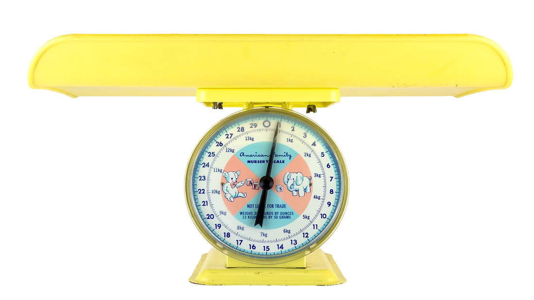 Yellow baby scale for a baby shower