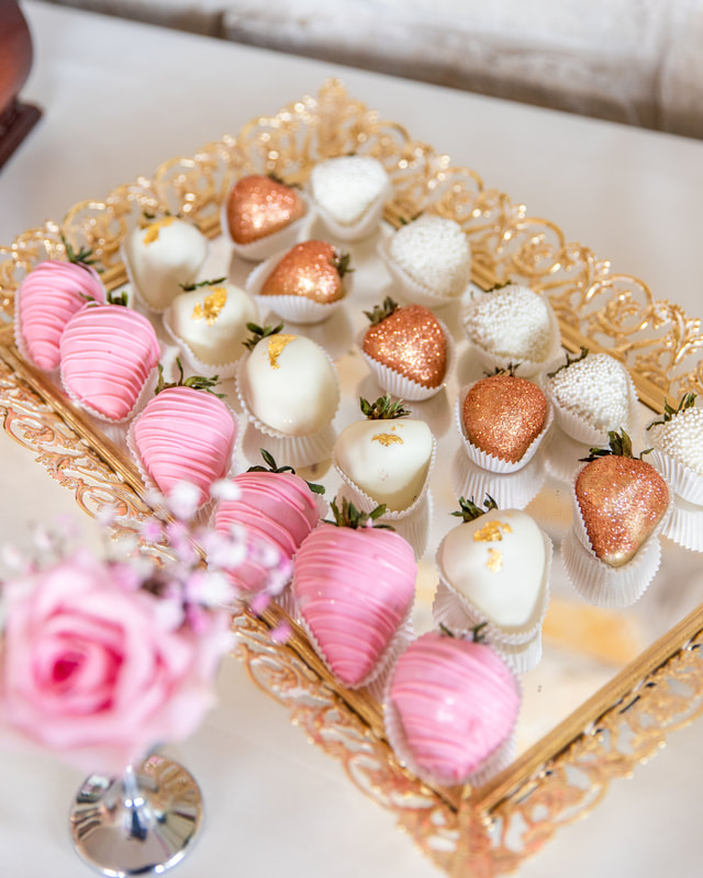 Chocolate covered Strawberries on a gold mirror tray. Pink frosting and gold leafing for a baby shower in Rockford Illinois Party Rental.