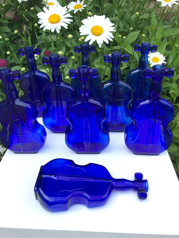 Fancy blue violin bottles for wedding centerpieces