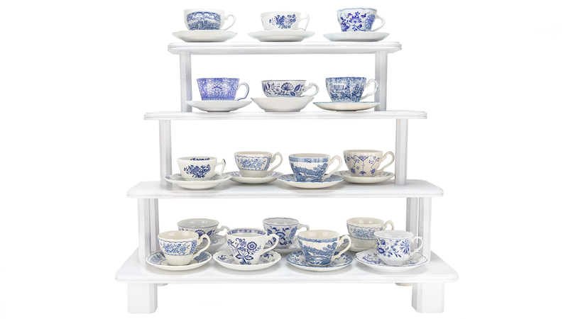 Blue and white teacups and saucers on white tiered stand