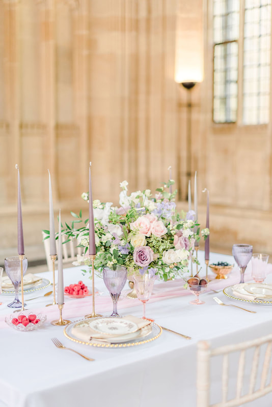 Peri Lavender and pink goblets for rent on a table with brass candle holders along with lavender and blush florals