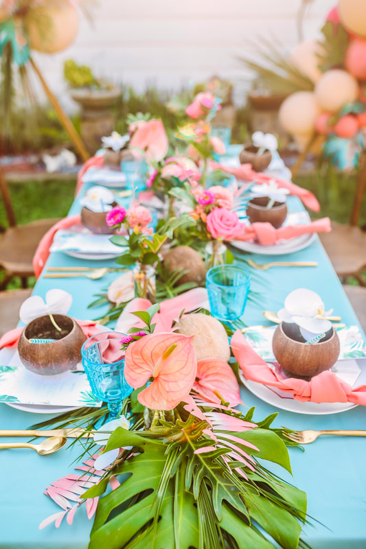 Ice blue glassware on a turquoise and pink table