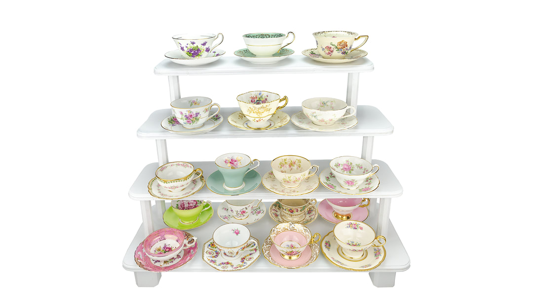 Elegant Floral teacups and saucers on white wooden stand