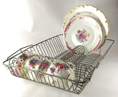 Vintage dish drainer holding vintage cups and plates