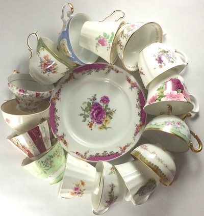 Teacup rentals in a circle around a vintage plate. 