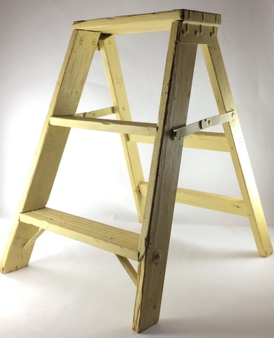Yellow two step ladder used for decor