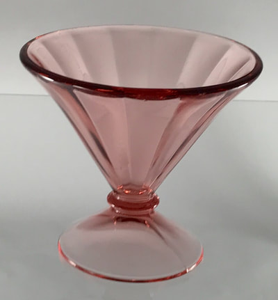 Pink depression glass dish used on a sweet table or grazing table