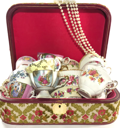 Mismatched teacups in a jewelry box