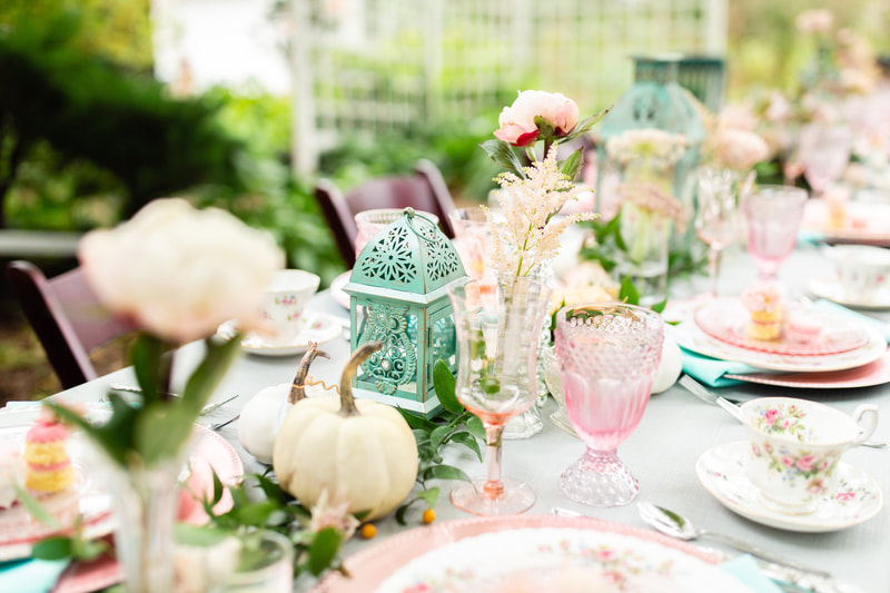 Pink water and wine glass rentals on a fall table with china plates and white pumpkins in Wisconsin