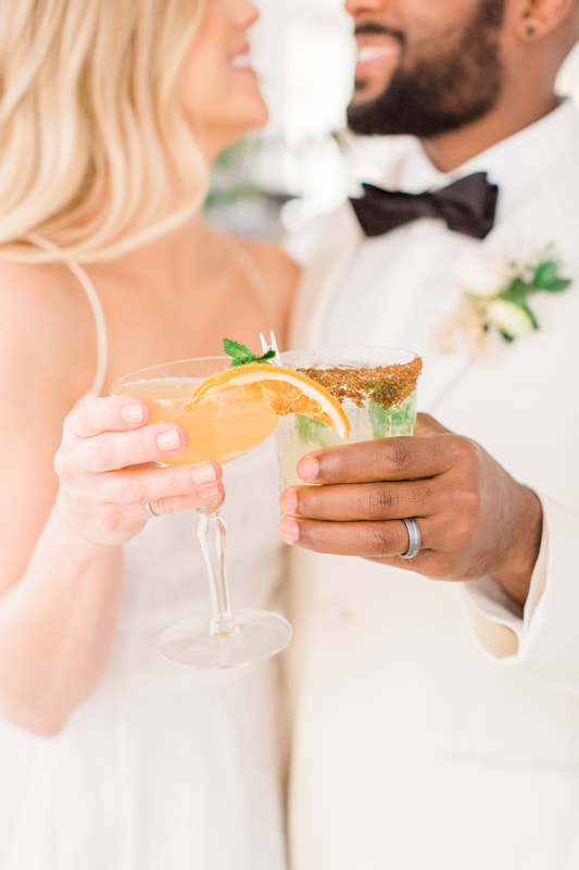 wedding couple holding cocktail glasses at Providence Vineyard in Hebron IL
