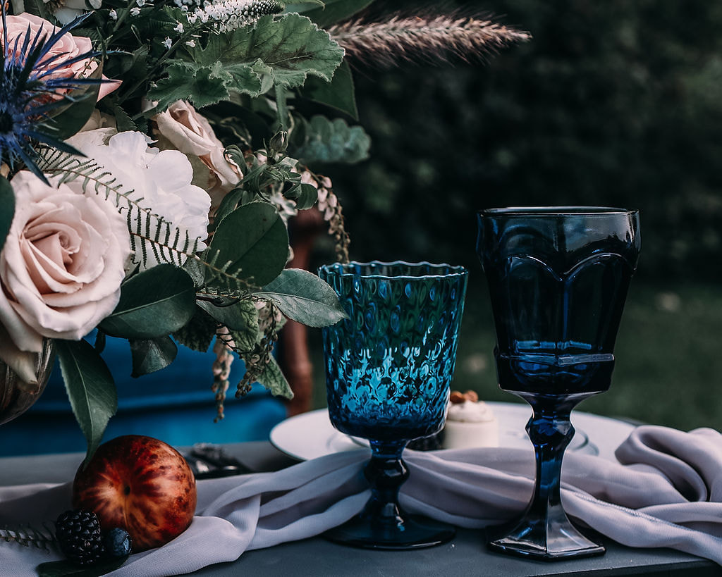 navy blue goblets, lavender linens, white lace dinnerware collection
