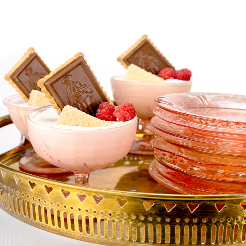 Mirrored gold tray with pink depression glass sorbet cups and salad/dessert plates rentals
