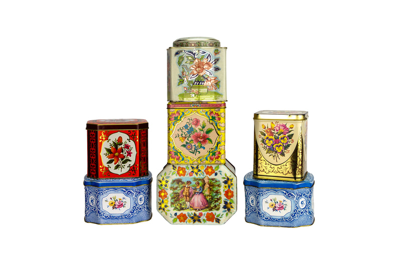 Tea tins stacked with pretty designs for rent