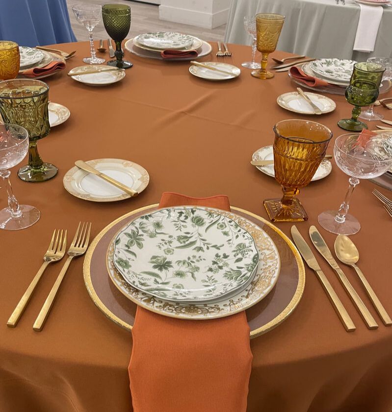 Gold rimmed hammered charger, brushed gold flatware, Glorious Gold dinner plate and bread/butter plate, Fern toile salad plate, amber and olive goblets. etched champagne coupes are ready for a wedding reception at Providence Vineyard!