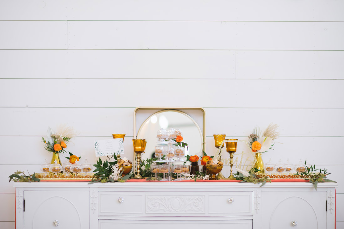 Sweet table, amber peg cups, brass candle holders, gold mirrored trays