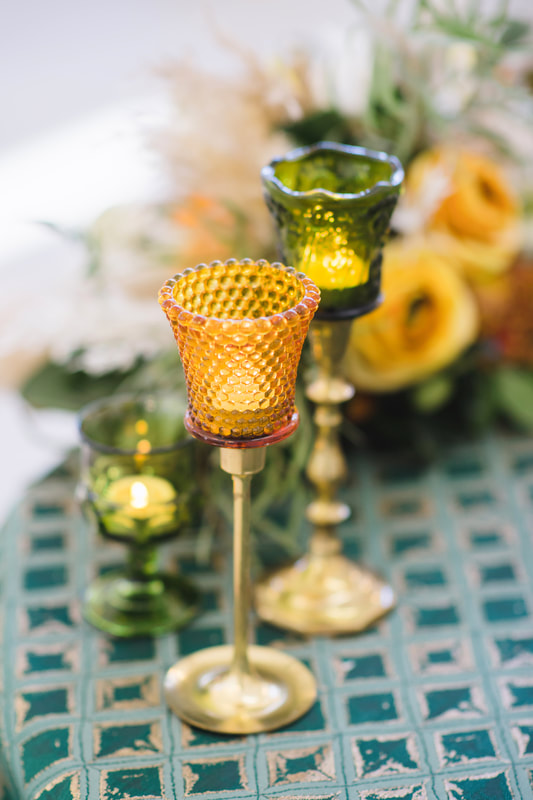 brass candlesticks, amber and olive green peg cups, olive green cordial votives